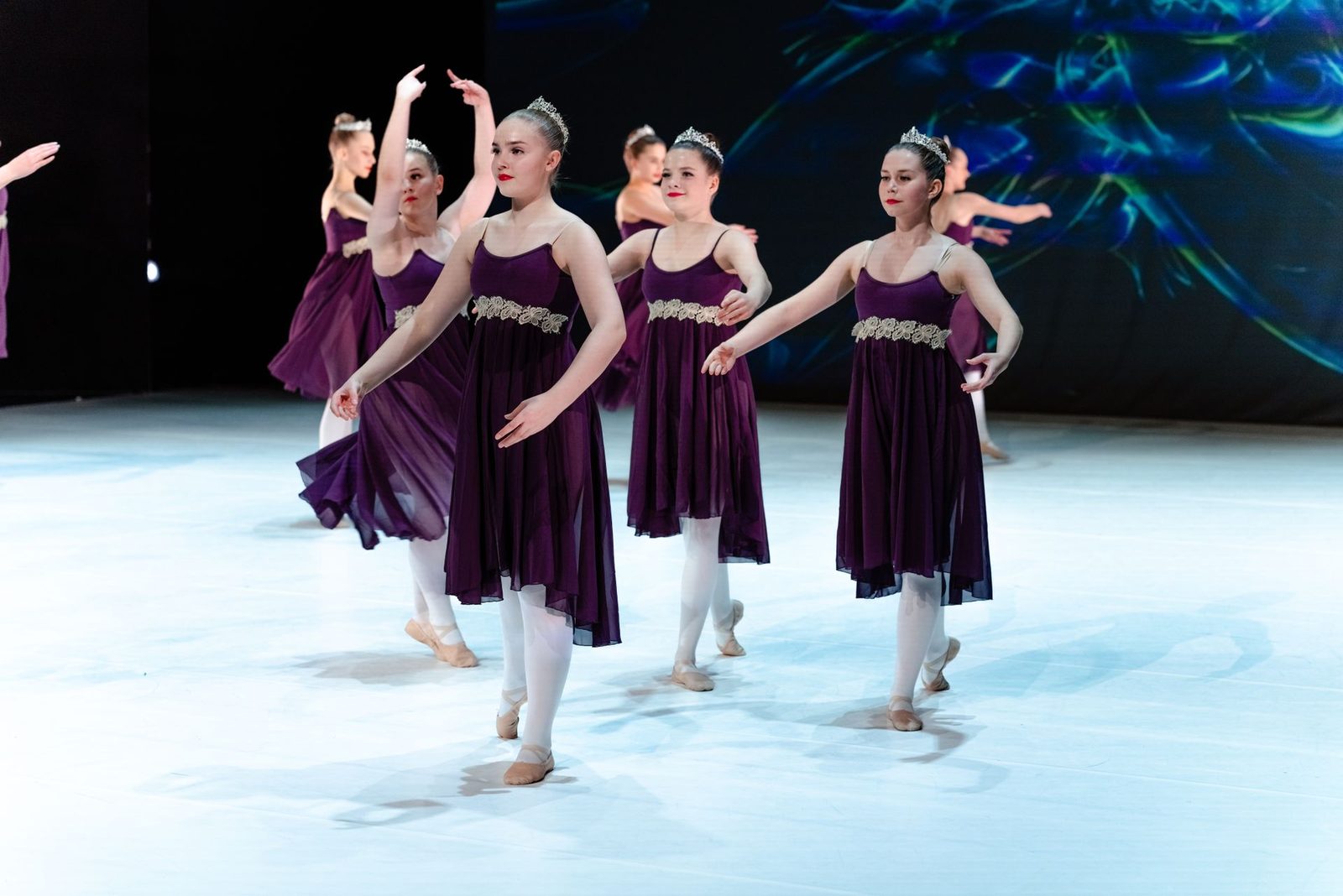 Young dancers performing on stage in matching costumes